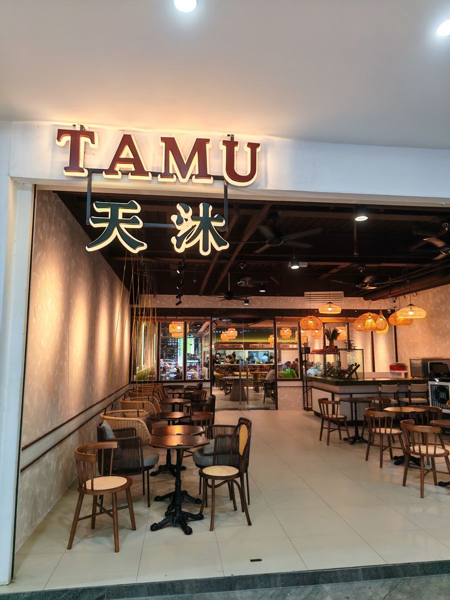 Tamu Kopitiam shopfront with rattan lamps and timber tables