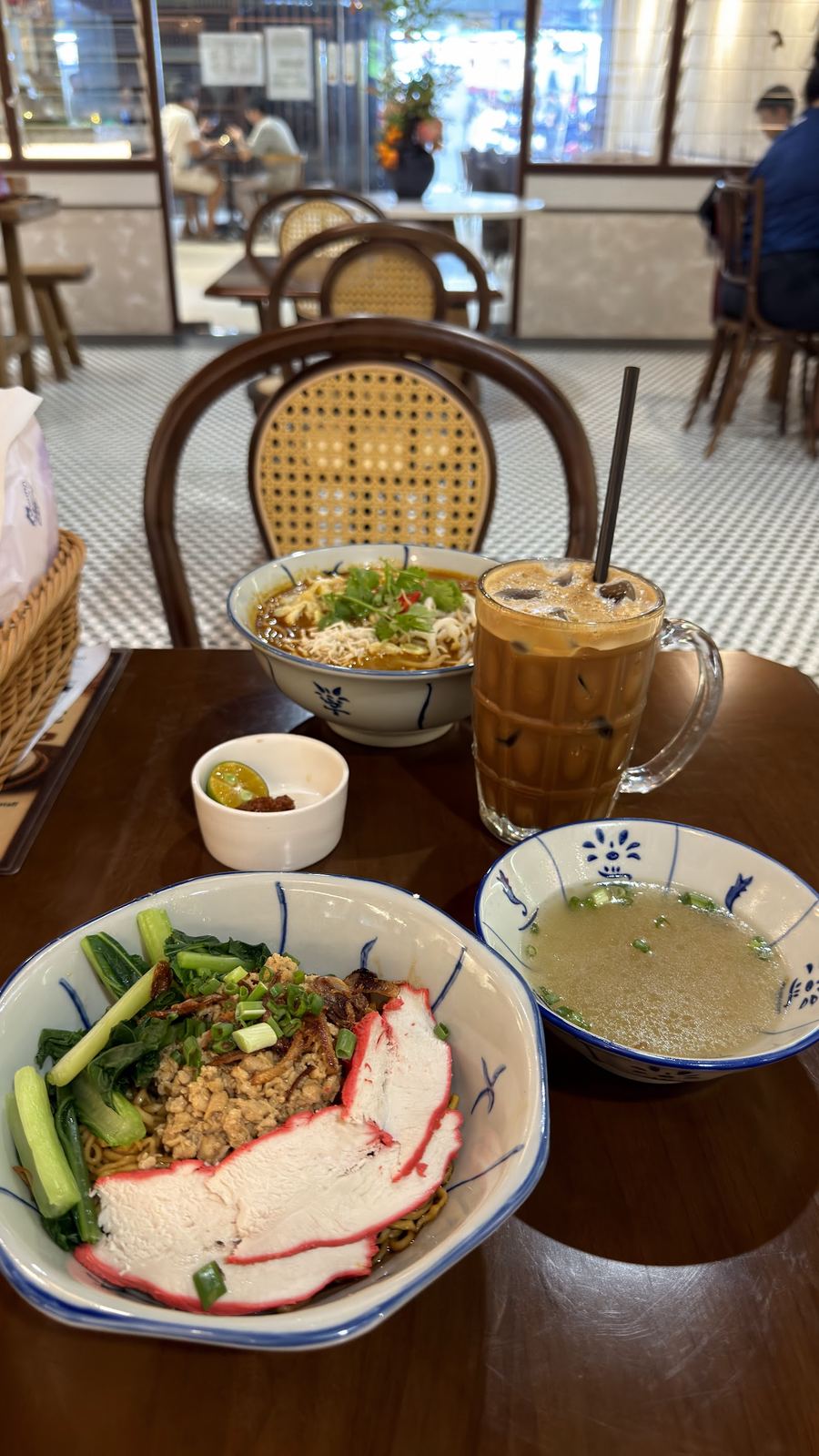 Noodles and iced coffee in blue-and-white bowls